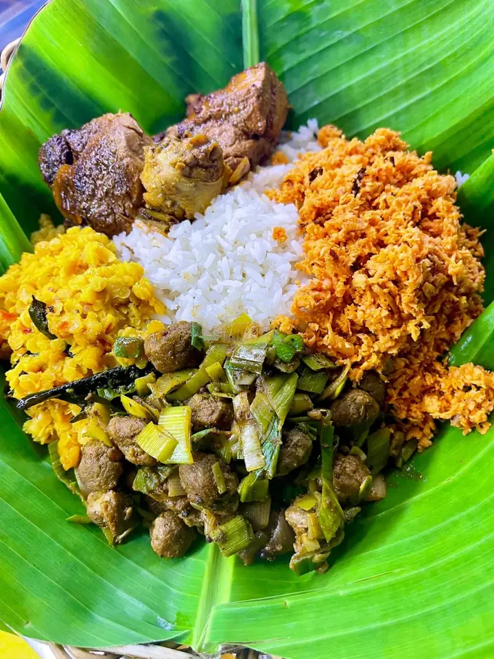 Sri Lankan rice and curry with colourful accompaniments on a banana leaf