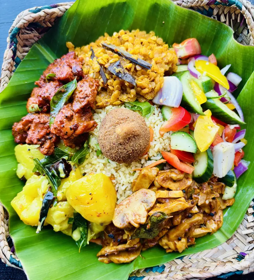 WellOn rice and curry with vegetables on a banana leaf